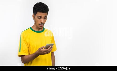 Männlicher schwarzer Athlet mit uniformem lokenden Handy-Kamera. Sportler isoliert auf weißem Hintergrund. Stockfoto