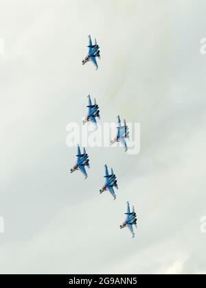 Kämpfer Su-35 Russische Ritter sind am Himmel über Schukowski zu sehen. Ein umfangreiches Programm für die 15. MAKS Air Show wurde von den Kunstflugteams "Russian Knights", "Swifts", "Falcons of Russia" und "berkuts" vorbereitet, die die Luftwaffe der Russischen Föderation repräsentieren. Die Piloten des russischen First Flight Kunstflugteams und natürlich die Gäste aus Indien - das SARANG Hubschrauber Kunstflugteam - nahmen ihr Flugzeug über Schukowski in den Himmel. Stockfoto