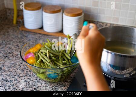 Frische Kidney Beans im Blanchierprozess mit Eiswasser Stockfoto
