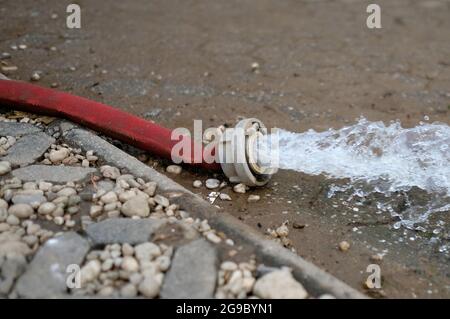 Wasserschaden - Wasser wird nach heftigen Regenfällen aus einem überfluteten Keller in Köln gepumpt. Stockfoto