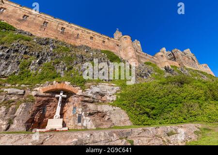 Marmorkreuz-Kriegsdenkmal in den Mauern von Bamburgh Castle an der Nordostküste Englands, bei dem Dorf Bamburgh in Northumberland Stockfoto