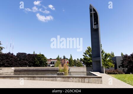 Das Kreuz- und reflektierende Becken vor der Kapelle des heiligen Ignatius auf dem Campus der Seattle University in Seattle, Washington, USA. Stockfoto