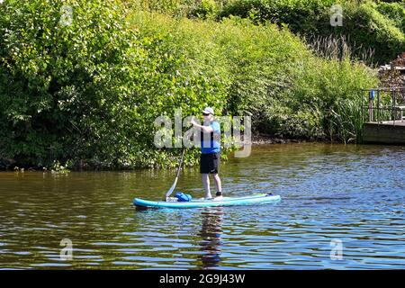 Chester, Cheshire, England - 2021. Juli: Person Paddle Boarding auf dem Fluss Dee, der durch Chester verläuft. Stockfoto