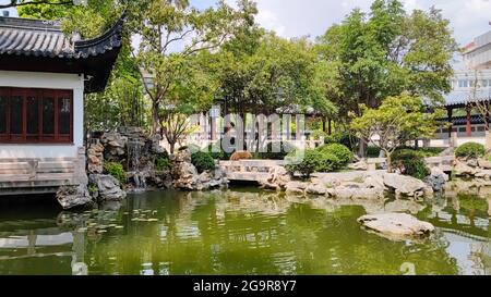 Klassischer chinesischer Innenhof mit kleiner Brücke und Wasser. Stockfoto