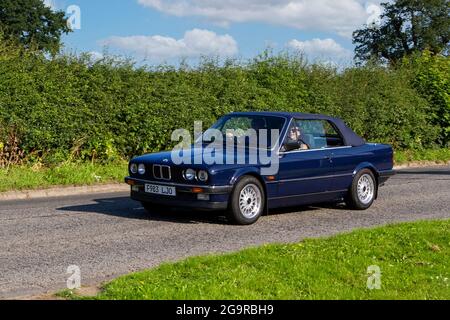1989 80s blauer BMW 320i 1990cc Fahrzeug auf dem Weg zur Capesthorne Hall classic July Car Show, Ceshire, UK Stockfoto