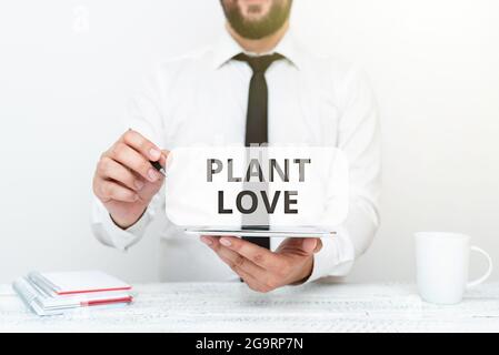 Konzeptionelle Bildunterschrift Plant Love. Ein Wort, das auf einem Symbol für emotionale Liebe, Fürsorge und Unterstützung geschrieben wurde, zeigte anderen, die Kommunikationstechnologie präsentierten Stockfoto