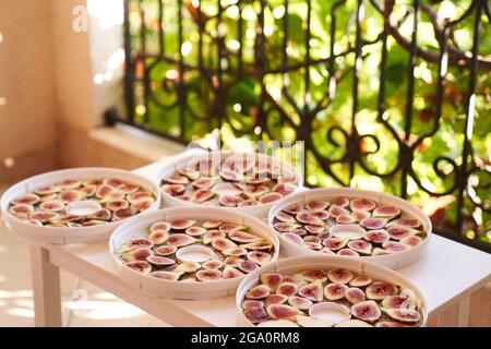Trockenprozess der Früchte auf den Tellern auf dem Balkontisch Stockfoto