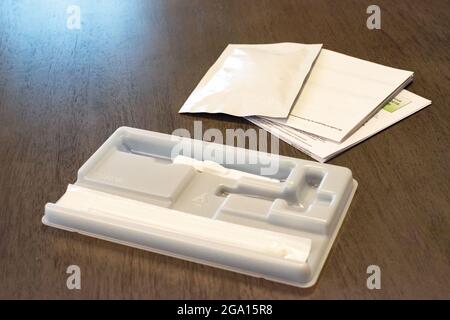 COVID-19 PCR-Heimtestkits werden immer prominenter und erschwinglicher, wie dieser Mann zeigt, der einen Test in seinem Haus abnimmt. Stockfoto