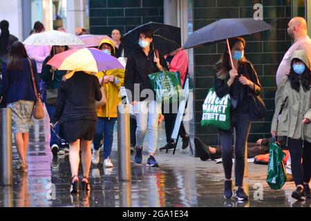 Manchester, Großbritannien. Juli 2021. UK Wetter: Gewitter und Starkregen in Manchester, UK. Die Menschen versuchen, den Regen im Stadtzentrum zu vermeiden. Quelle: Terry Waller/Alamy Live News Stockfoto