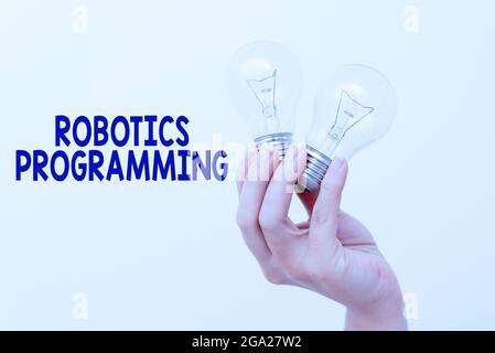 Konzeptionelle Bildunterschrift Robotics Programming. Business Concept Software, die zur Durchführung autonomer Aufgaben Hand halten zwei Lampe zeigen oder präsentieren verwendet Stockfoto