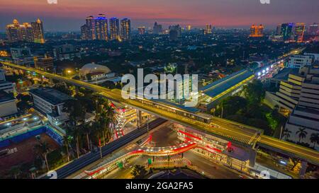 Luftaufnahme der artikulierten Stadtbusse, die am Busbahnhof in der Nähe des Hauptbahnhofs MRT-Linie bei Kebayoran Baru ankommen und abfahren. Jakarta, Indonesien, Ju Stockfoto