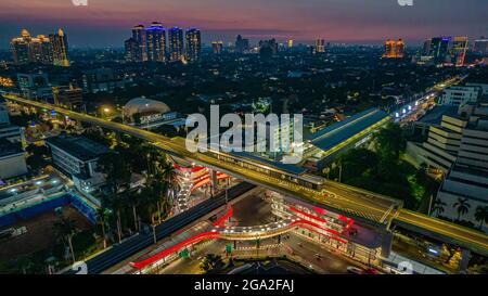 Luftaufnahme der artikulierten Stadtbusse, die am Busbahnhof in der Nähe des Hauptbahnhofs MRT-Linie bei Kebayoran Baru ankommen und abfahren. Jakarta, Indonesien, Ju Stockfoto