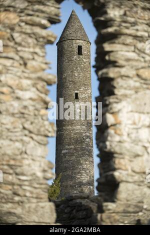 Nahaufnahme des Rundturms durch ein Lanzettenfenster, das sich in Glendalough (oder dem Tal der zwei Seen) öffnet, dem Ort eines frühchristlichen Mönchs... Stockfoto