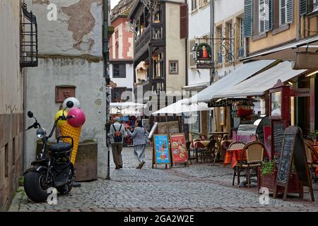 STRASSBURG, FRANKREICH, 23. Juni 2021 : Restaurant Terrassen in einer kleinen Straße des touristischen Zentrums von Straßburg. Stockfoto