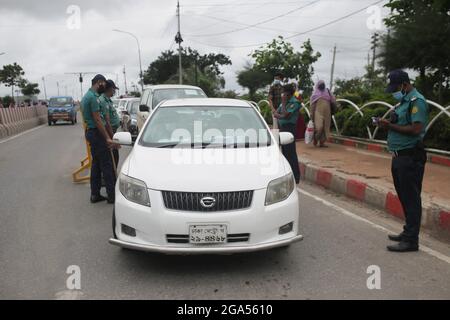 Dhaka, Bangladesch. Juli 2021. Polizeipersonal stoppt Pendler bei der Einreise in die Hauptstadt an einem Kontrollpunkt, da Reisebeschränkungen angekündigt wurden, um die Ausbreitung des Coronavirus Covid-19 in Dhaka einzudämmen. (Bild: © MD Mehedi Hasan/ZUMA Press Wire) Stockfoto