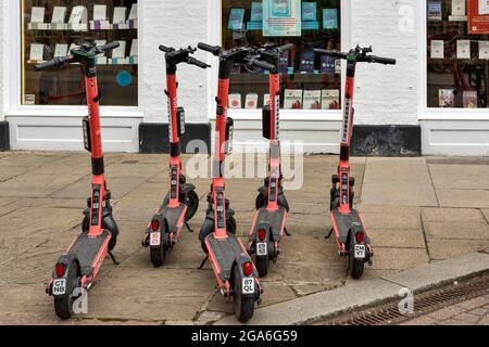 ROSAFARBENE VOI E-SCOOTER VON CAMBRIDGE ENGLAND VOR DEM PRESSEGEBÄUDE DER CAMBRIDGE UNIVERSITY IN DER TRINITY STREET Stockfoto