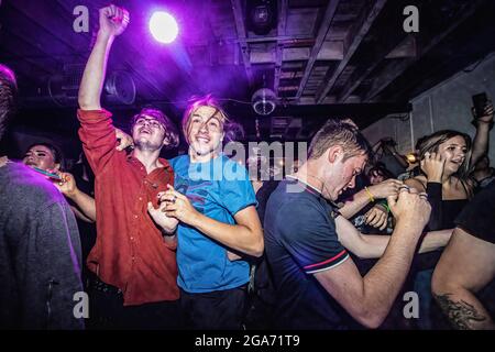 Manchester, Großbritannien. Juli 2021. Zwei Nachtschwärmer springen herum, während sie eine Nacht im Aatma in Manchester genießen. Free Strangers Headlined zusammen mit Lucid Dreams und The Redeemers für ihren ersten großen Auftritt seit der Pandemie. Dies ist einer der ersten großen Auftritte des Aatma Nightclub, der aufgrund der Pandemie in achtzehn Monaten veranstaltet wurde. Kredit: SOPA Images Limited/Alamy Live Nachrichten Stockfoto