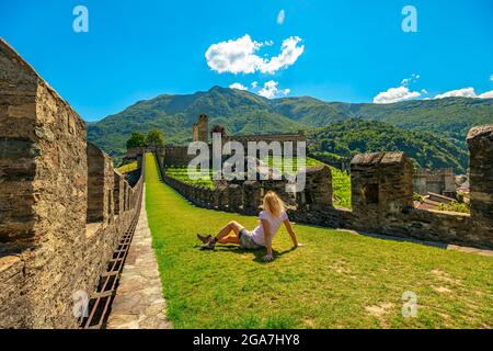 Frau auf der Spitze von Bellinzona, der historischen Stadt in der Schweiz. Mauern des Schlosses Montebello in Bellinzona, Hauptstadt des Kantons Tessin Stockfoto