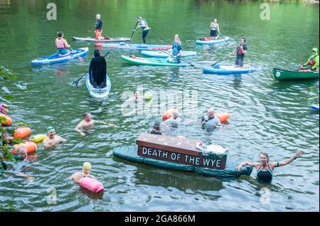 Die Spezialistin für Wildschwimmen und Autorin Angela Jones alias „The Wild Woman of the Wye“ führt ein 1-km-Bad im Monmouth-Abschnitt des Wye-Flusses, um auf den katastrophalen ökologischen Zustand des Flusses Wye und seine anhaltende Verschlechterung aufmerksam zu machen. Ein Nachbau-Sarg auf einem Paddelbrett wurde in den Fluss gesenkt und von Angela geschleppt, um den Tod des Wye darzustellen. Ihr Schwimmen ist Teil der #SaveTheWye, einer Dachkampagne zur Unterstützung und zum Aufbau eines Netzwerks von Organisationen und Einzelpersonen, die sich für den Schutz und die Wiederherstellung der Gesundheit des Flusses Wye und seiner Nebenflüsse einsetzen, sowohl für die Tierwelt als auch für die Menschen Stockfoto