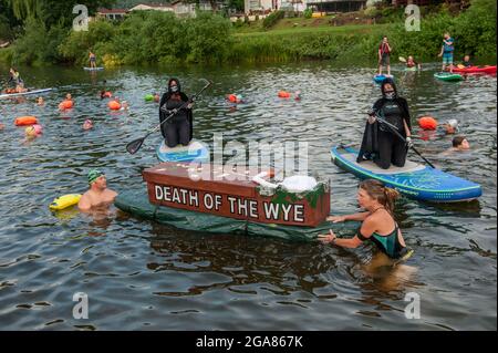 Die Spezialistin für Wildschwimmen und Autorin Angela Jones alias „The Wild Woman of the Wye“ führt ein 1-km-Bad im Monmouth-Abschnitt des Wye-Flusses, um auf den katastrophalen ökologischen Zustand des Flusses Wye und seine anhaltende Verschlechterung aufmerksam zu machen. Ein Nachbau-Sarg auf einem Paddelbrett wurde in den Fluss gesenkt und von Angela geschleppt, um den Tod des Wye darzustellen. Ihr Schwimmen ist Teil der #SaveTheWye, einer Dachkampagne zur Unterstützung und zum Aufbau eines Netzwerks von Organisationen und Einzelpersonen, die sich für den Schutz und die Wiederherstellung der Gesundheit des Flusses Wye und seiner Nebenflüsse einsetzen, sowohl für die Tierwelt als auch für die Menschen Stockfoto