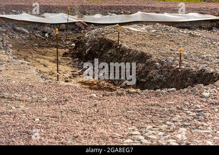 Flacher Graben für ein kleines Fundament ausgegraben. Stockfoto