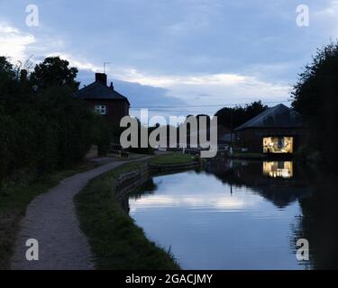 Braunston, Northamptonshire, Großbritannien, 29. Juli 2021: Licht beleuchtet das Innere einer Werkstatt am Canalside neben Schleusentoren am Grand Union Canal. Stockfoto