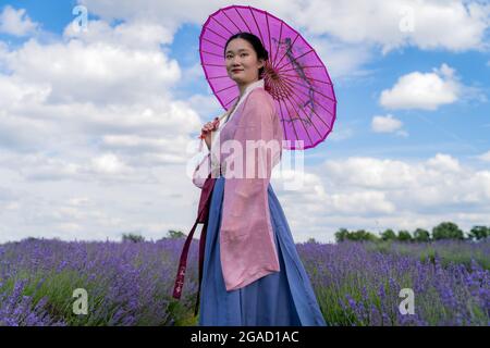 Sutton, Großbritannien. Juli 2021. UK Wetter: Die Londoner Tanzstudentin Yuaner Xu genießt die Sonne auf der Mayfield Lavender Farm in ihrem traditionellen chinesischen Kleid. Kredit: Guy Corbishley/Alamy Live Nachrichten Stockfoto