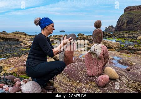 Caroline Walker, Steinstapler, balanciert Steine bei der European Stone Stacking Championship am Strand, Dunbar, East Lothian, Schottland, Großbritannien Stockfoto