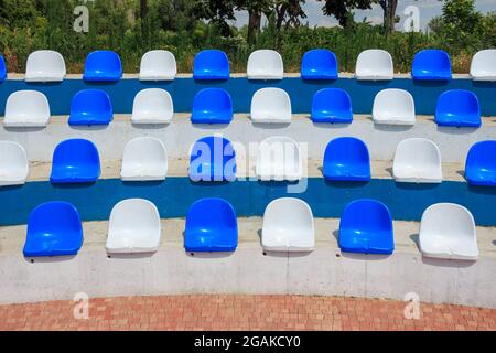 Leere Stadionstühle in blau-weißen Farben Stockfoto