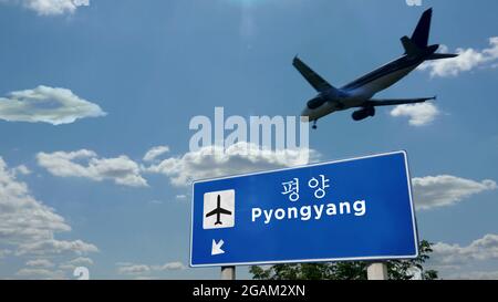 Flugzeug Silhouette Landung in Pjöngjang, Nordkorea. Ankunft in der Stadt mit dem internationalen Flughafen Richtung Schild und blauem Himmel. Reisen, Reisen und tran Stockfoto