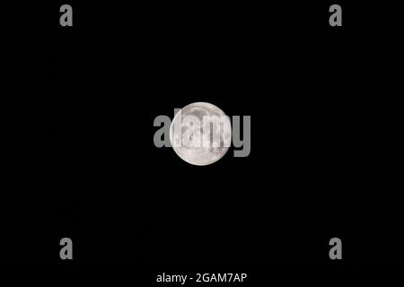 Strahlend weißer Vollmond am dunklen Nachthimmel. Mystischer schwarzer Nachthimmel mit Mond, dunkle Ruhe. Perigee Night, Mond am nächsten zur Erde Stockfoto