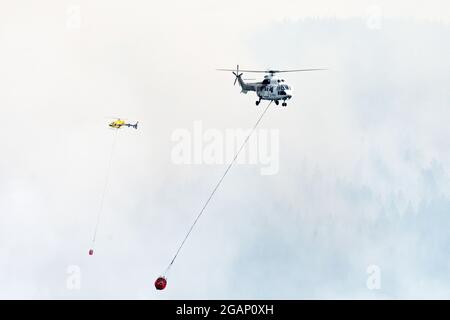 Zwei Hubschrauber, die in den Purcell Mountains im Nordwesten von Montana gegen South Yaak schießen. (Foto von Randy Beacham) Stockfoto