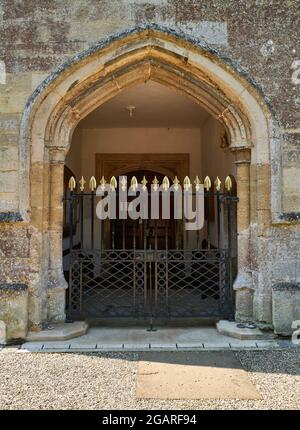 Die gewölbte Eingangshalle und das Tor der christlichen Kirche St. Mary and All Saints aus dem 15. Jahrhundert im englischen Dorf Fotheringhay. Stockfoto