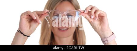 Die junge Frau von Portre mit schlechter Sehkraft hält eine Brille in den Händen Stockfoto