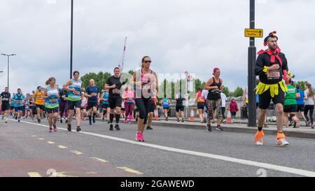 Menschen, die den London Landmarks Half Marathon laufen, um Geld für wohltätige Zwecke zu sammeln. London - 1. August 2021 Stockfoto