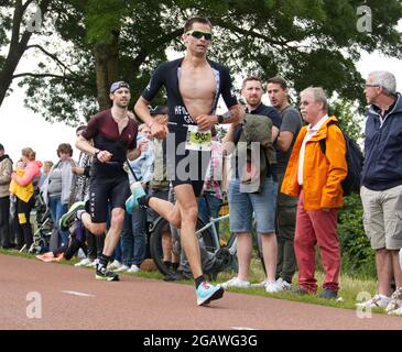 Maastricht, Niederlande. August 2021. John Heiland (Startnummer 902) aus Deutschland läuft beim Ironman 70.3 Maastricht-Limburg Triathlon um den zweiten Platz. Aufgrund des schnell fließenden Wassers in der Maas nach den jüngsten Überschwemmungen wurde der Schwimmabschnitt der Strecke durch einen zusätzlichen Laufabschnitt ersetzt, was den Triathlon zu einem Run-Bike-Run-Event machte. Anna Karpendale/Alamy Live News Stockfoto