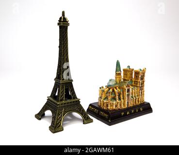 Eiffelturm und Notre-Dame-Kathedrale Figur isoliert auf weißem Hintergrund. Souvenir aus Paris. Metallfiguren von Pariser Wahrzeichen. Stockfoto