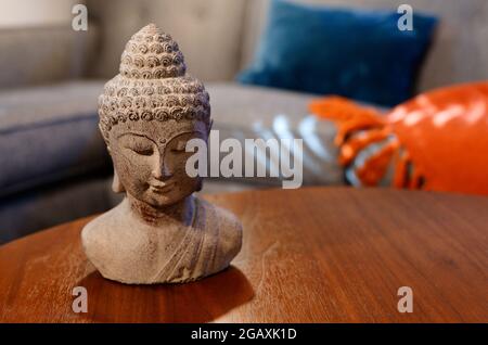 Buddhistische Statue, die auf einem Holztisch in der Höhle ruht Stockfoto