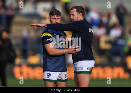 George Williams (31) von Warrington Wolves nimmt während des Vorspielaufwärmens Anweisungen von Teamkollege Blake Austin (6) Stockfoto