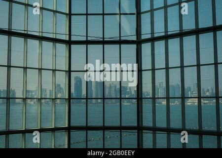 Doha, Katar - 13. Oktober 2019: Der Blick auf den Schatten der Stadt durch das Glasfenster des Museums für Islamische Kunst, eines der vollständigsten Sammlergattern der Welt Stockfoto