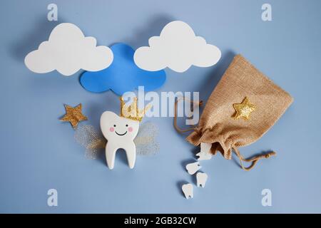 Nationaler Tag Der Zahnfee. Kinder haben eine Fee. Niedlicher Zahn mit Flügeln, einer Krone und einem Zauberstab und einer Tasche mit Zähnen. Stockfoto