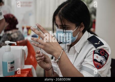 Jerusalem, Israel. August 2021. Sanitäter von Magen David Adom, der als israelische Organisation des Roten Kreuzes und führender Rettungsdienst tätig ist, liefern Senioren in der Assisted Living Residence für ältere Menschen in Mishan Gonen einen dritten BioNTech Pfizer-Auffrischungsimpfstoff. PM Bennett kündigte sein Ziel an, bis Ende August 2021 alle israelischen Senioren, 60 und höher, mit einem 3. Impfstoff zu impfen, obwohl eine Auffrischungsimpfung noch nicht von der US-amerikanischen FDA zugelassen wurde. Kredit: Nir Alon/Alamy Live Nachrichten Stockfoto