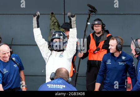 Damon Hill feiert, nachdem er mehrere Hochgeschwindigkeits-Demonstrationsrunden in seinem Weltmeisterschaftssieger Williams FW18 Formel-1-Auto beim Silverstone Classic 2021 absolviert hat Stockfoto