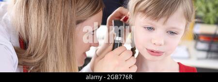 Doktor untersucht Ohr mit einem Otoskop zu kleinen Mädchen Stockfoto