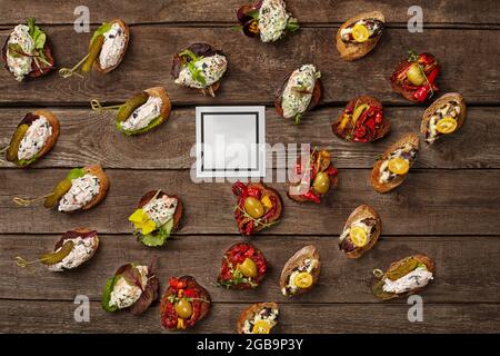 Bruschettas-Set mit verschiedenen Belägen auf Holzoberfläche Stockfoto