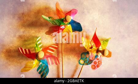 Drei Spielzeugwindmühlen auf stilisiertem Hintergrund Stockfoto