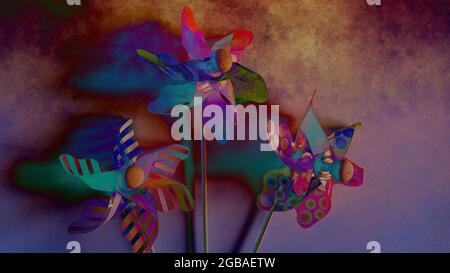 Drei Spielzeugwindmühlen auf stilisiertem Hintergrund Stockfoto