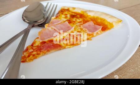 Stücke von frischer Pepperoni Pizza auf einem Teller Stockfoto