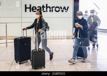 London, Großbritannien. August 2021. Passagiere, die Gesichtsmasken tragen, um die Ausbreitung des Coronavirus zu verhüten, kommen am Londoner Heathrow Airport Terminal 2 an. Ab gestern können vollständig geimpfte Reisende aus den Vereinigten Staaten und einem großen Teil Europas ohne Selbstisolierung nach Großbritannien einreisen. (Foto von Tejas Sandhu/SOPA Images/Sipa USA) Quelle: SIPA USA/Alamy Live News Stockfoto