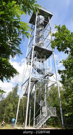 30. Juli 2021, Sachsen, Rötha/OT Mölbis: Auf dem rund fünf Kilometer langen Rundwanderweg auf dem Schlackenhaufen bei Mölbis befindet sich ein 30 Meter hoher Aussichtsturm, der einen Blick auf die ehemals schmutzige und jetzt grüne Landschaft bietet. Die Renovierung des Rundweges mit Sitzmöbeln, Wegweisern und Designokaten ist eines der Projekte der Dorfentwicklungsgesellschaft, Dazu gehört neben der Neugestaltung des Schlossparks in der Dorfmitte auch der Schlackenhaufen, der zu DDR-Zeiten von Bürgerrechtlern als Wallfahrtsort genutzt wurde. Mölbis wurde berühmt in Th Stockfoto